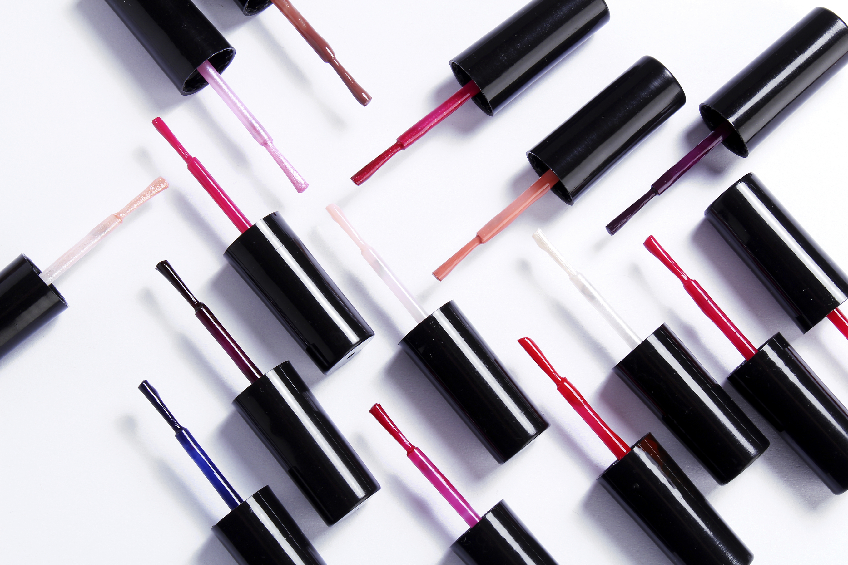 Various nail polish brushes isolated on white background Professional